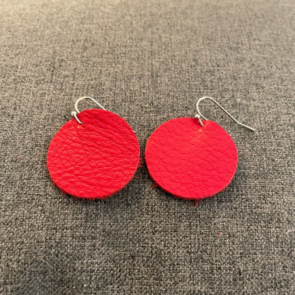 Red leather circle shaped pierced earrings